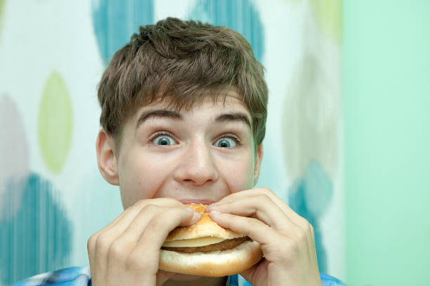 istock Teenager with burger 479533844