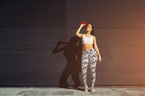 istock Fit woman drinking energy drink  on blank copy space 479536506