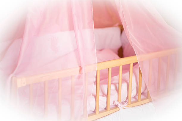 istock Children's wooden bed with pink bed linen 479538402