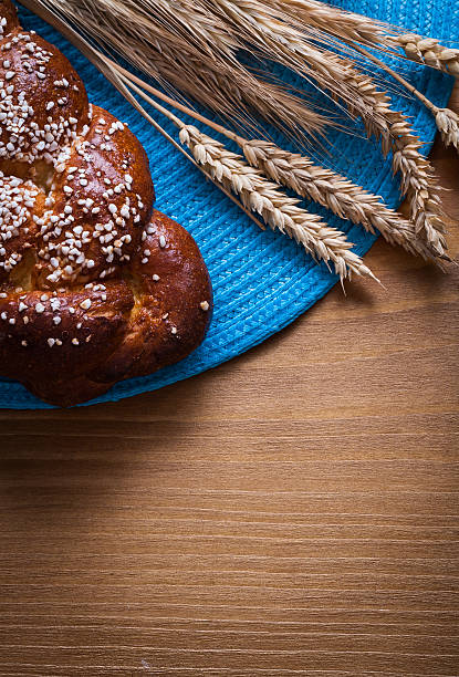 istock Fresh-baked bun wheat rye ears with wicker table-cloth 479538684