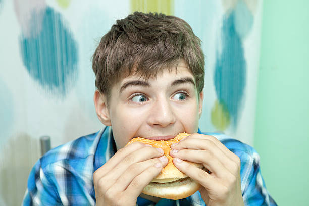 istock Teenager with burger 479539034