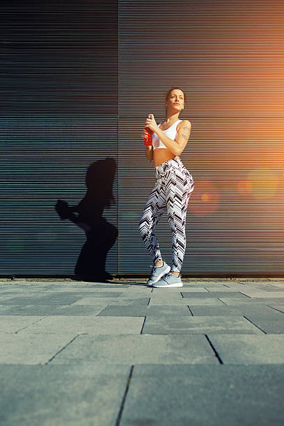 istock Female runner holding energy drink  against blank copy space 479539276