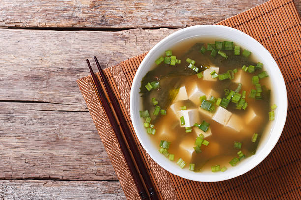 Japanese miso soup in a white bowl horizontal top view Japanese miso soup in a white bowl on the table. horizontal view from above bamboo material photos stock pictures, royalty-free photos & images