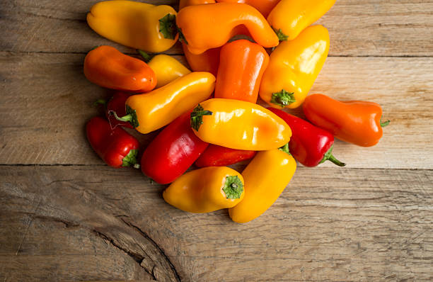 istock Colored bell peppers on a weathered wood background. 479542434