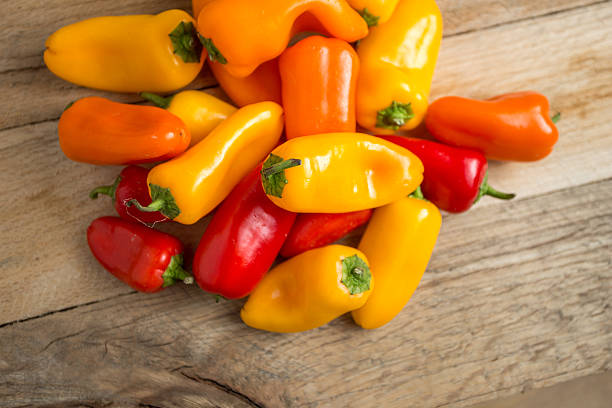 istock Colored bell peppers on a weathered wood background. 479542442
