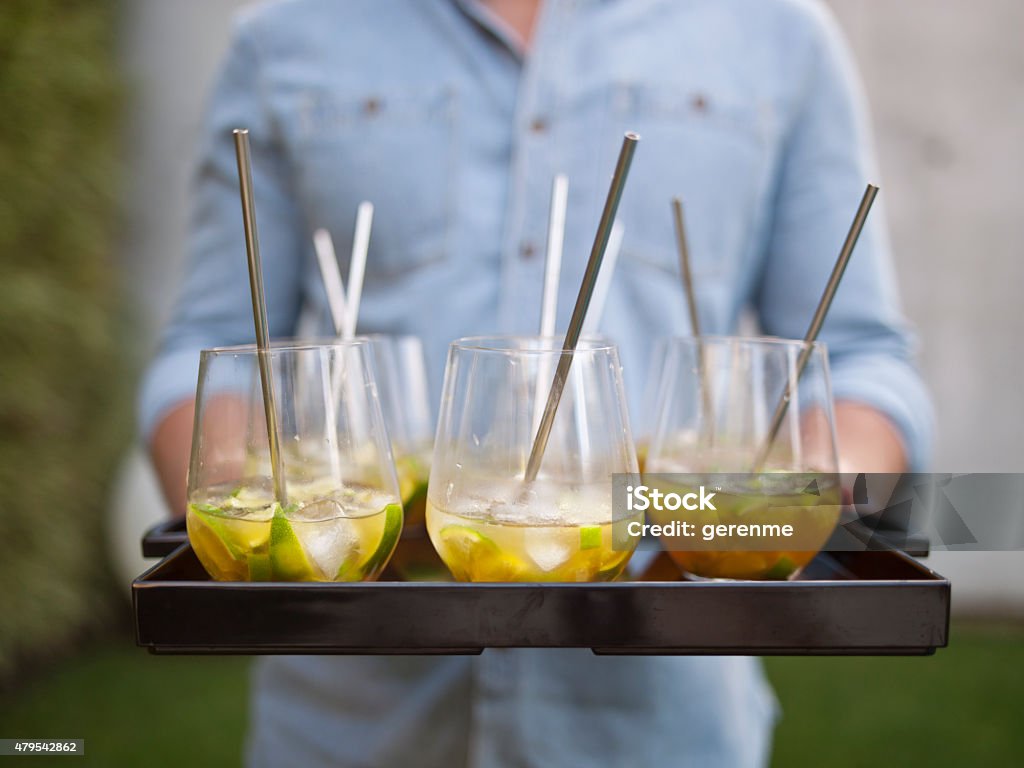 cocktail  time person serving a tray of cocktails Punch - Drink Stock Photo