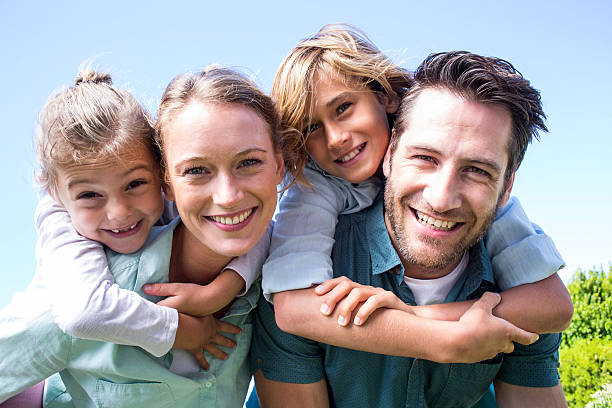 glückliche eltern mit ihren kindern - family summer portrait nature stock-fotos und bilder