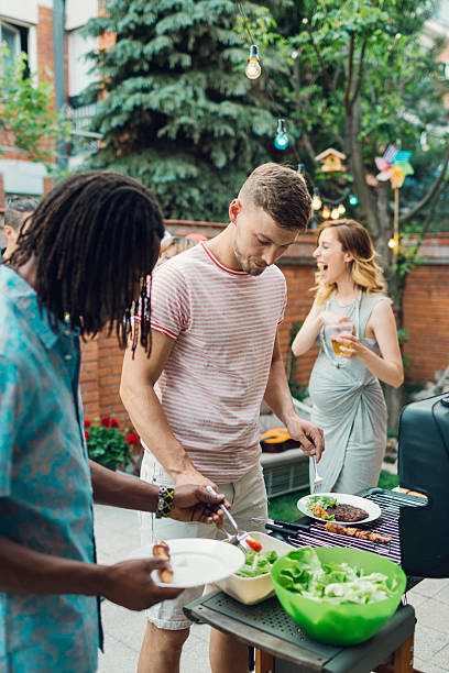 istock Young People Eating At Barbecue Party. 479545440