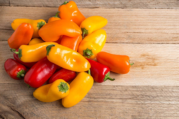 istock Colored bell peppers on a weathered wood background. 479545806