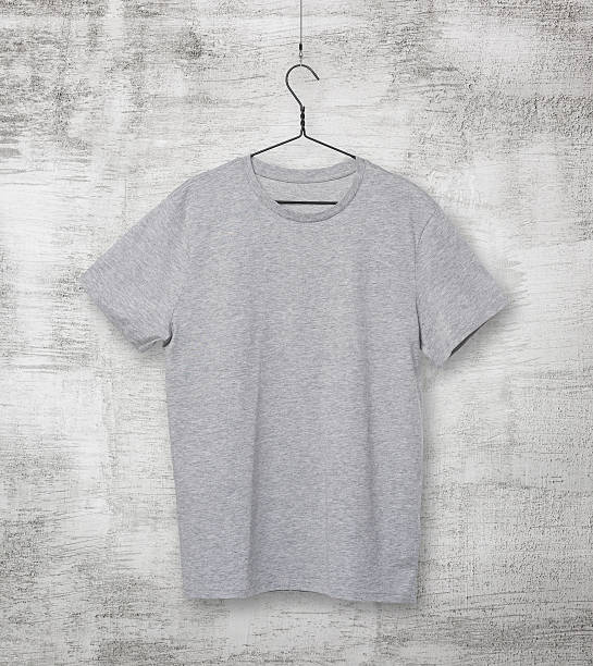 istock grey t-shirt on the clothes hanger. Concrete background. 479546388
