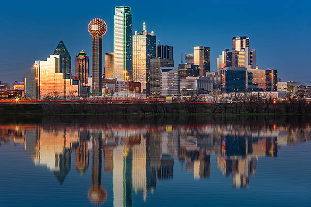 Dallas skyline at sunset Dallas skyline at sunset reflected in the flooded Trinity River dallas texas photos stock pictures, royalty-free photos & images