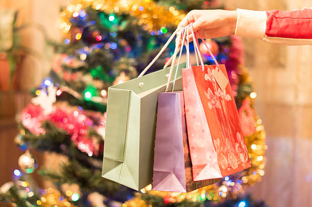 istock Gift bags in a female hand with Christmas tree 479549534