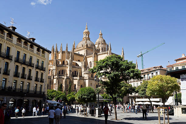 Segovia, Spain - September 14, 2014: Tourists and locals alike enjoying life in Plaza Mayor and the Gothic Cathedral   