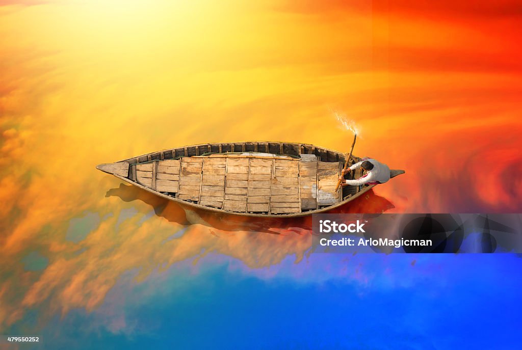 Boat in Bangladesh river Showing a Boatman riding the boat during sunset in Padma river in Bangladesh.  India Stock Photo