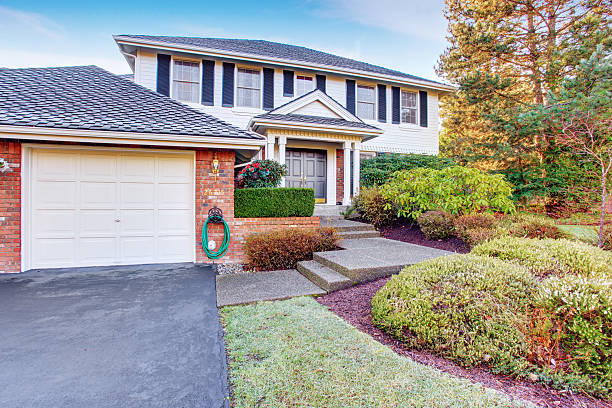 istock Brick house with greenery and driveway. 479552142