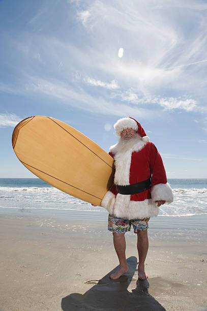 istock Santa Claus With Surf Board On Beach 479554501