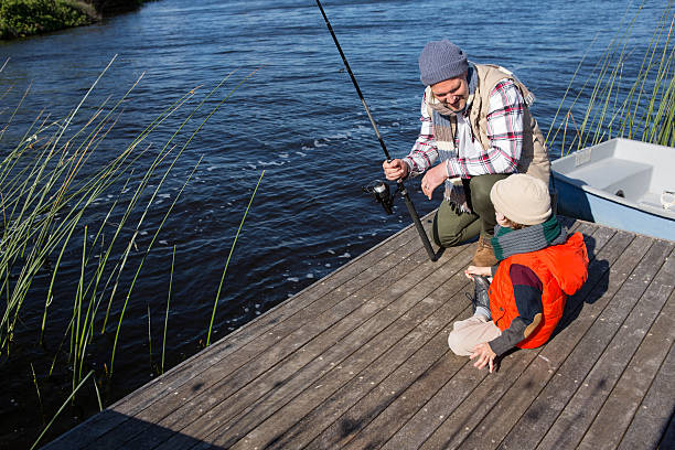 istock Happy man fishing with his son 479554674