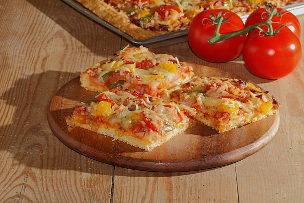 istock Pizza with peppers, tomatoes, ham, onion, cheese 479554772