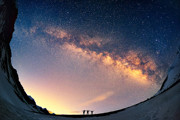Knocking on heaven's door Silhouettes of the people standing together holding hands against the Milky Way in the mountains. annapurna conservation area photos stock pictures, royalty-free photos & images