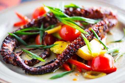 Freshly grilled lemon octopus, served with cherry tomato and chopped spring onion