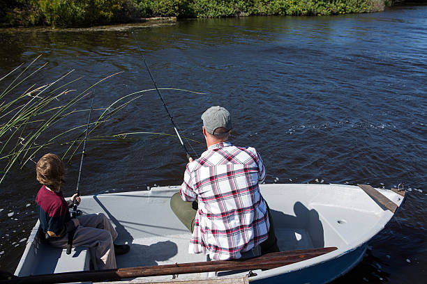 istock Happy man fishing with his son 479557766