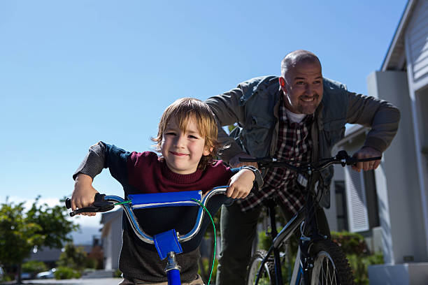 istock Happy father on a bike with his son 479557790