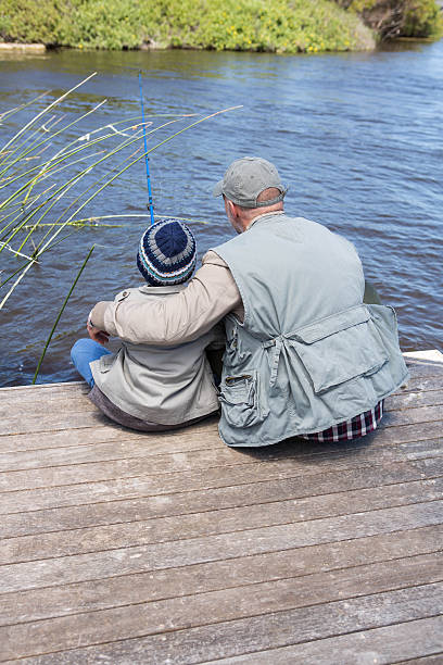 istock Father and son fihsing at a lake 479557878