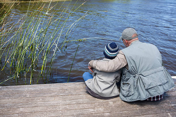 istock Father and son at a lake 479557882