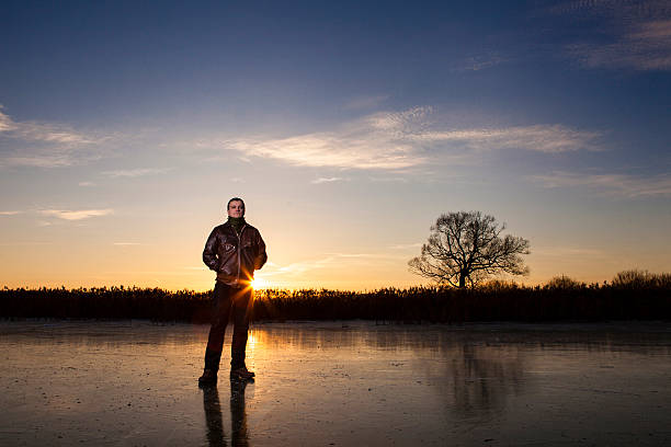 man standing on a frozen lake