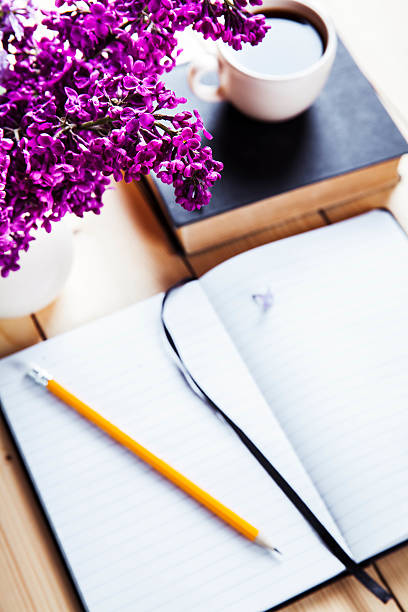 istock Beautiful lilac on office desk with book 479560722