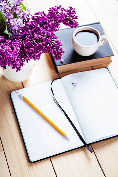 istock Beautiful lilac on office desk with book 479560866