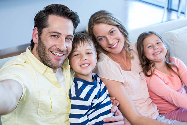 istock Happy family taking selfie on couch 479561448
