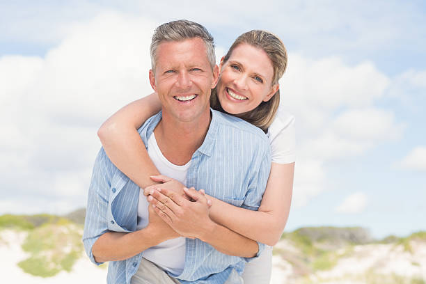 Happy couple having fun together Happy couple having fun together at the beach mature couple photos stock pictures, royalty-free photos & images