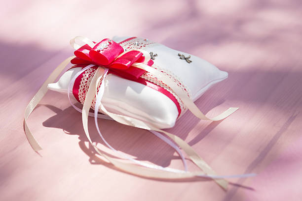 istock Red rings cushion on table with ribbons 479562036