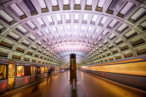 Washington DC, USA - April 10, 2015: Trains and passengers in the Foggy Bottom-GWU Metro Station. Opened in 1976, the Washington Metro is now the second-busiest rapid transit system in the U.S.