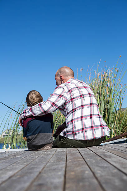 istock Happy man fishing with his son 479565444