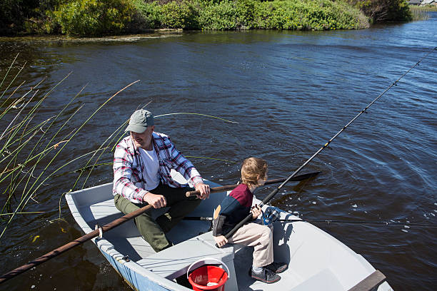 istock Happy man fishing with his son 479565454