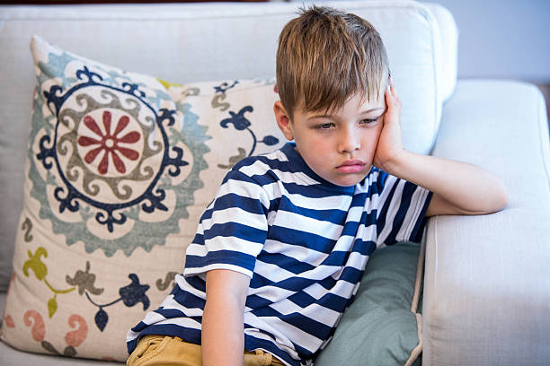 istock Tired little boy on the couch 479565528