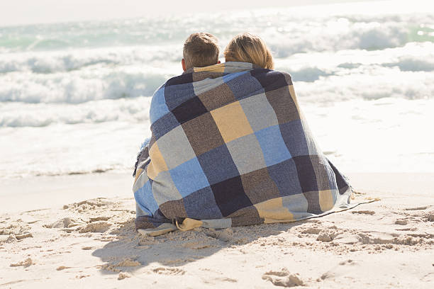 istock Happy couple wrapped up in blanket 479565626