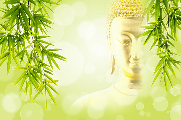 istock Bamboo leaves with face buddha on green background 479567720