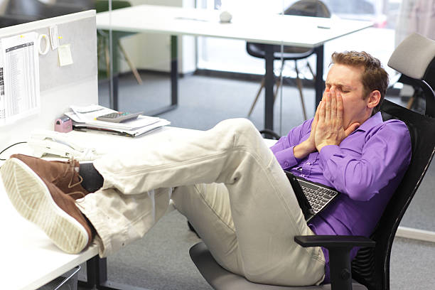 istock tired businessman yawning 479568185