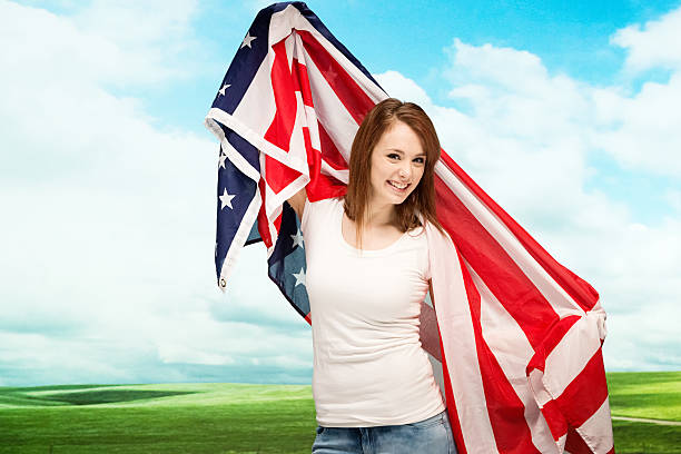 istock Happy female outdoors with American flag 479571727