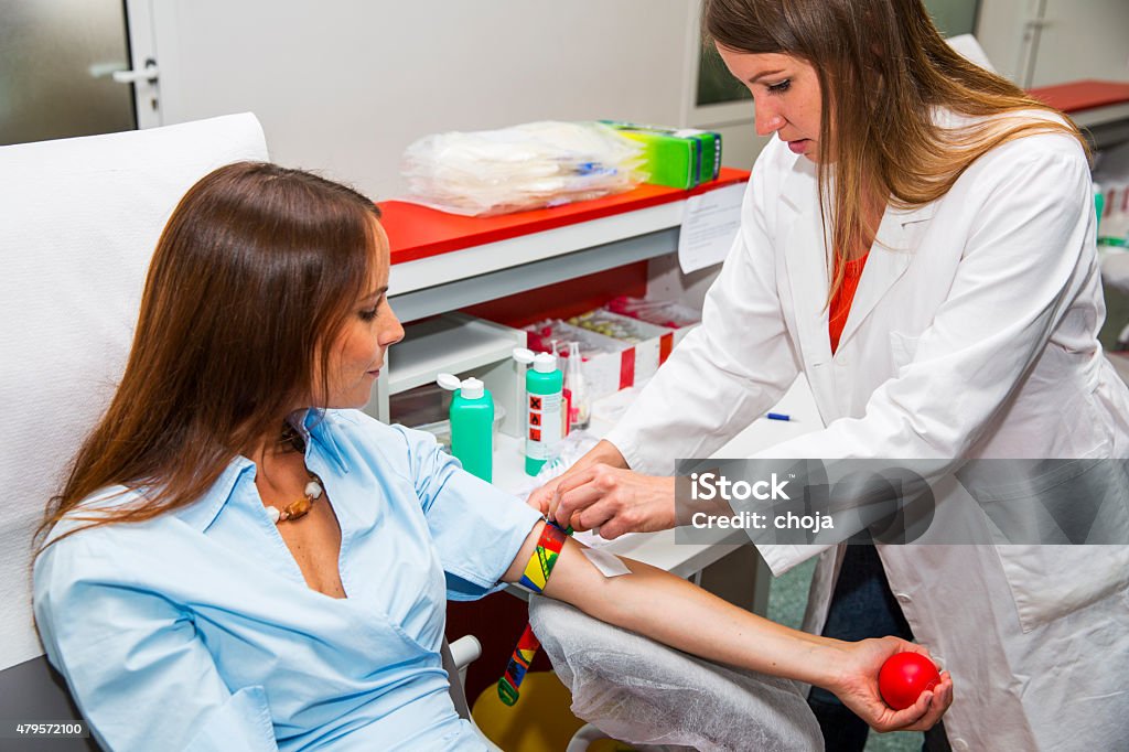 Young woman is going to donate blood in  blood bank Young woman is going to donate blood in a blood bank....young woman doctor making prepairs Blood Donation Stock Photo