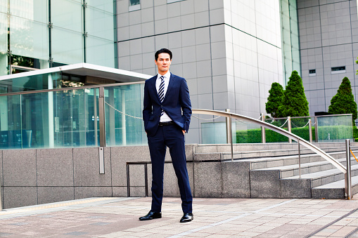 Portrait of japanese businessman in Tokyo, Background is modern business building. Concept for modern business and lifestyle. Image is taken during Tokyo istockalypse 2015.