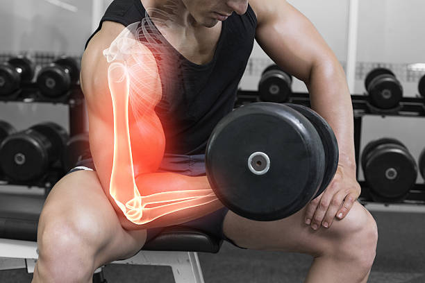 istock Highlighted arm of strong man lifting weights 479572666