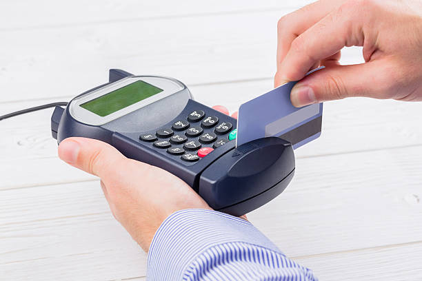 istock Man swiping his credit card 479572856