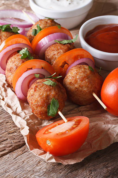 istock meatballs on skewers with onions and tomatoes. Vertical 479573496