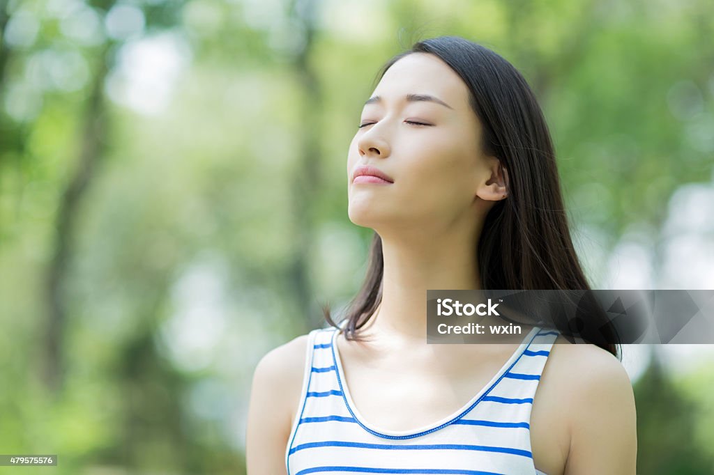 girl breathing asian girl outdoor breathe fresh air in the prak Holding Breath Stock Photo