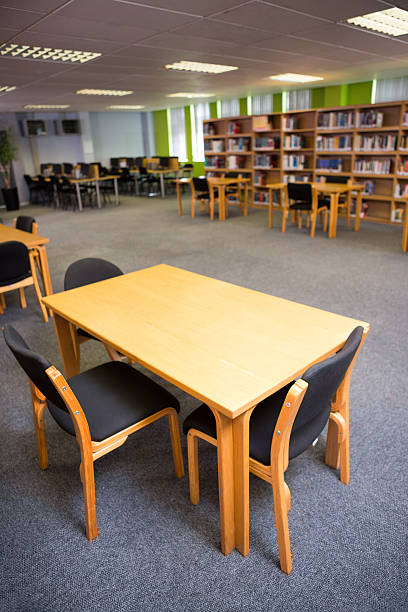 istock Empty seats and bookshelves at college library 479579080