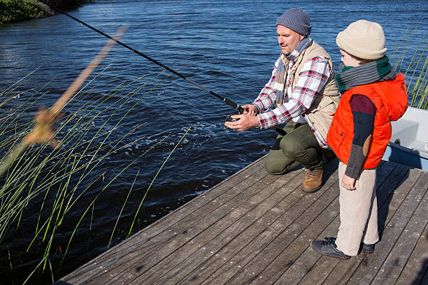 istock Happy man fishing with his son 479579598